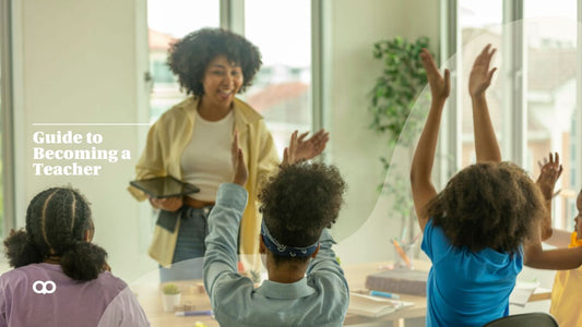 happy teacher at the front of the classroom with students raising their arms